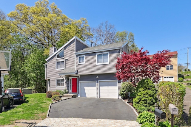 46 Fairway Grn, Fairfield, CT 06825 - view of front of home with aphalt driveway, a garage, a front lawn, and a chimney