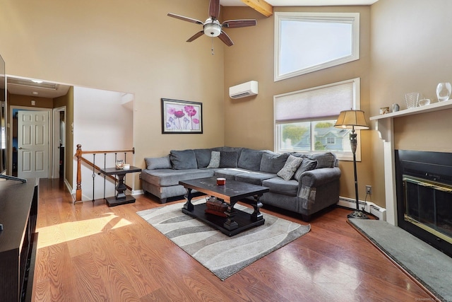 46 Fairway Grn, Fairfield, CT 06825 - living area with baseboard heating, wood finished floors, a towering ceiling, and a wall mounted AC