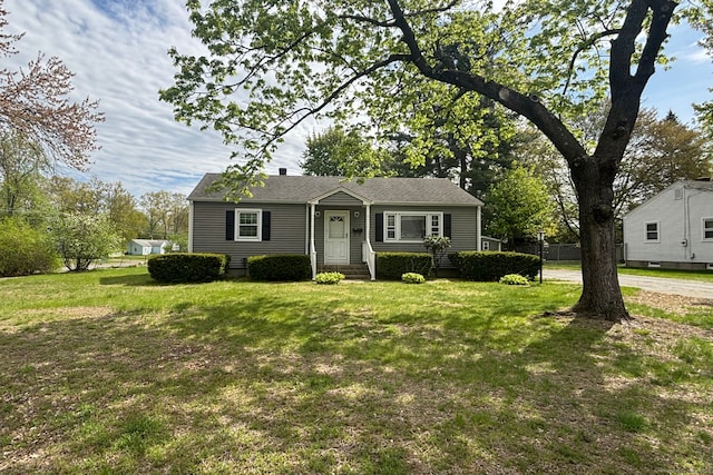 bungalow-style house with a front yard