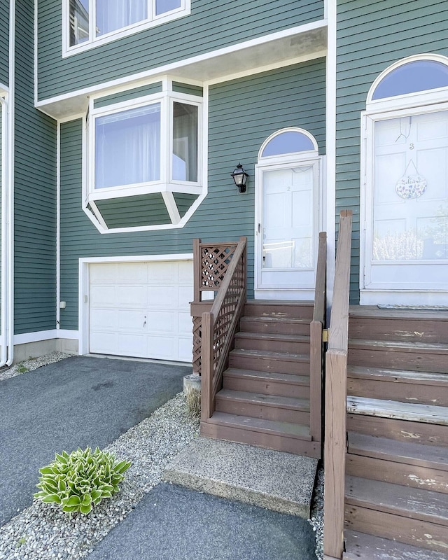 doorway to property with a garage