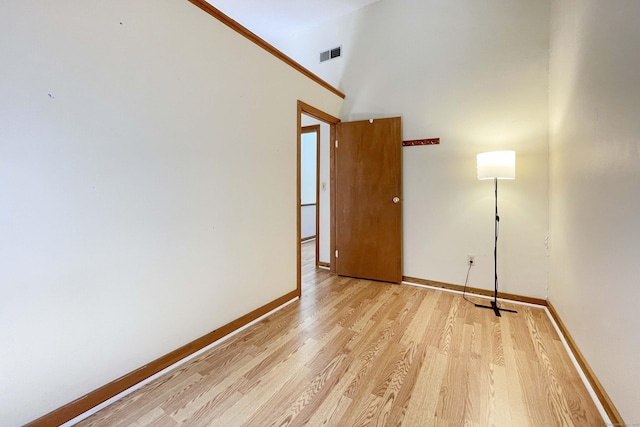 empty room with baseboards, light wood-style flooring, and visible vents