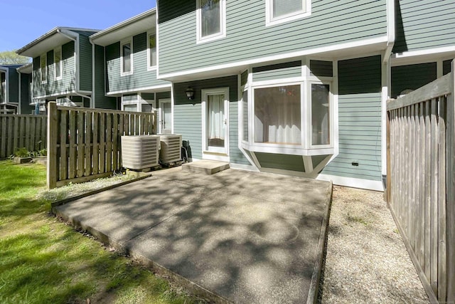 exterior space featuring fence and central AC unit