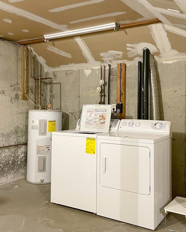 washroom featuring washing machine and clothes dryer, laundry area, and water heater