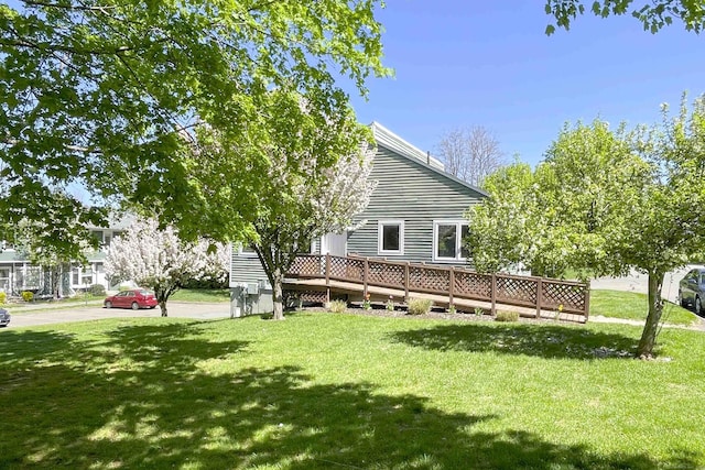 back of property featuring a yard and a deck
