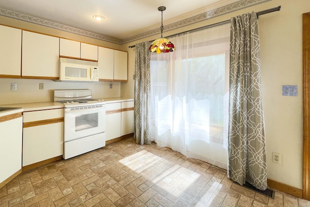 kitchen with white appliances, baseboards, hanging light fixtures, and light countertops