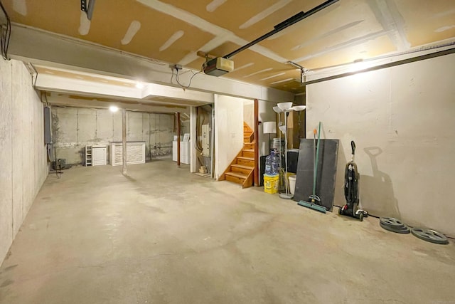 unfinished basement with washer / clothes dryer, stairs, and electric panel