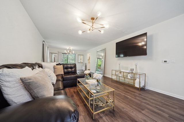 living room with an inviting chandelier, baseboards, and wood finished floors