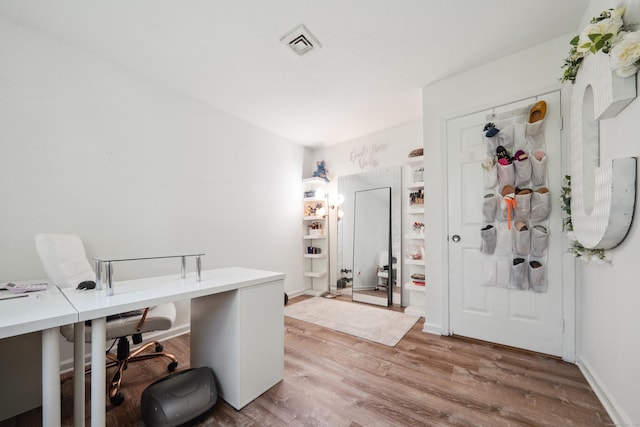 office space featuring visible vents and wood finished floors