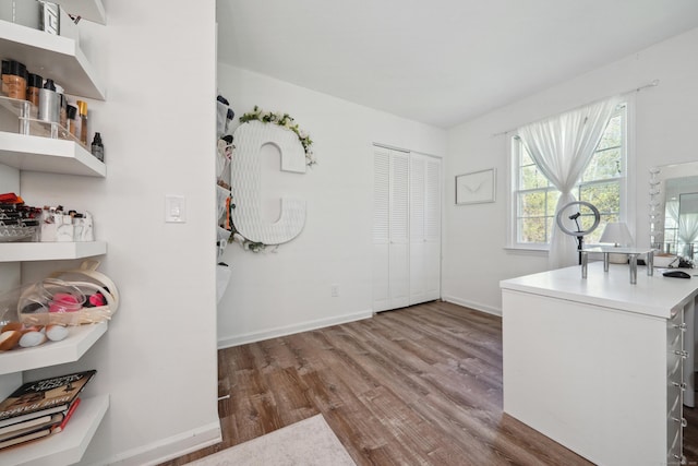 interior space featuring baseboards and wood finished floors
