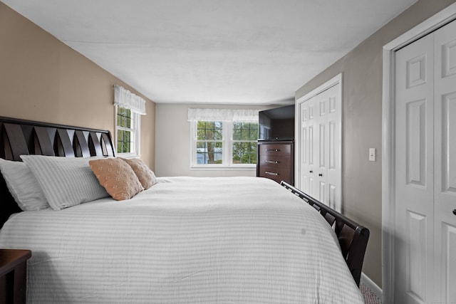 bedroom with carpet flooring, a closet, and baseboards