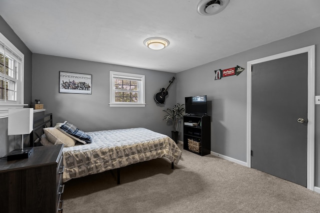 carpeted bedroom featuring baseboards