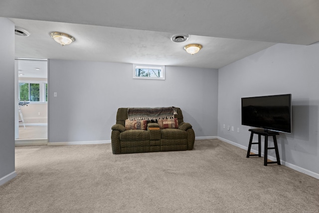 living area with baseboards and carpet floors
