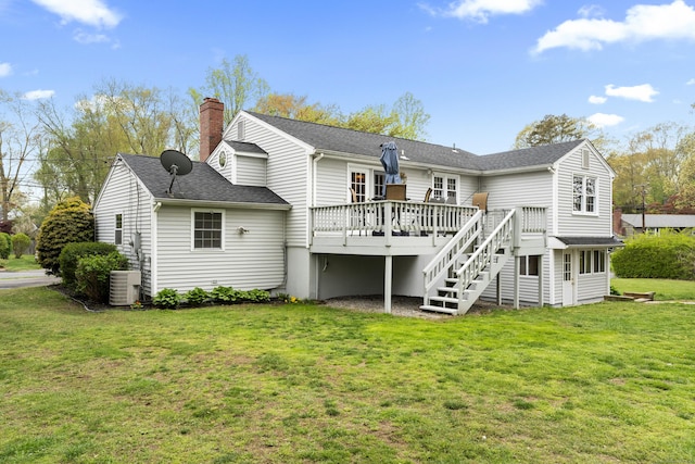 rear view of property featuring a chimney, a lawn, cooling unit, a deck, and stairway
