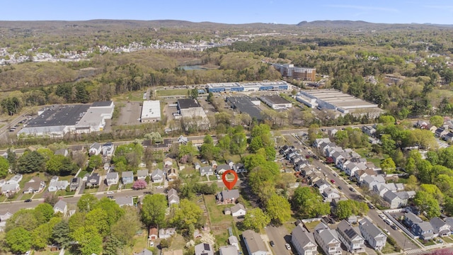 drone / aerial view featuring a residential view and a forest view