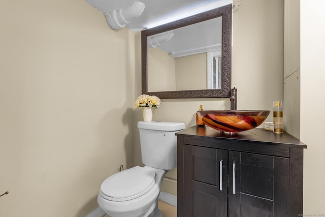 half bath featuring vanity and toilet