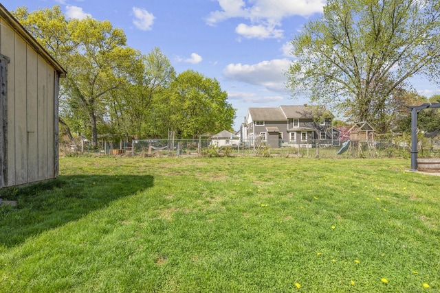 view of yard featuring a playground and fence