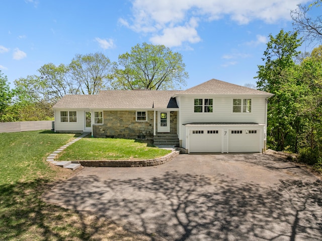 7 Richmond Hill Rd, Norwalk, CT 06854 - tri-level home with a front lawn, fence, stone siding, an attached garage, and driveway