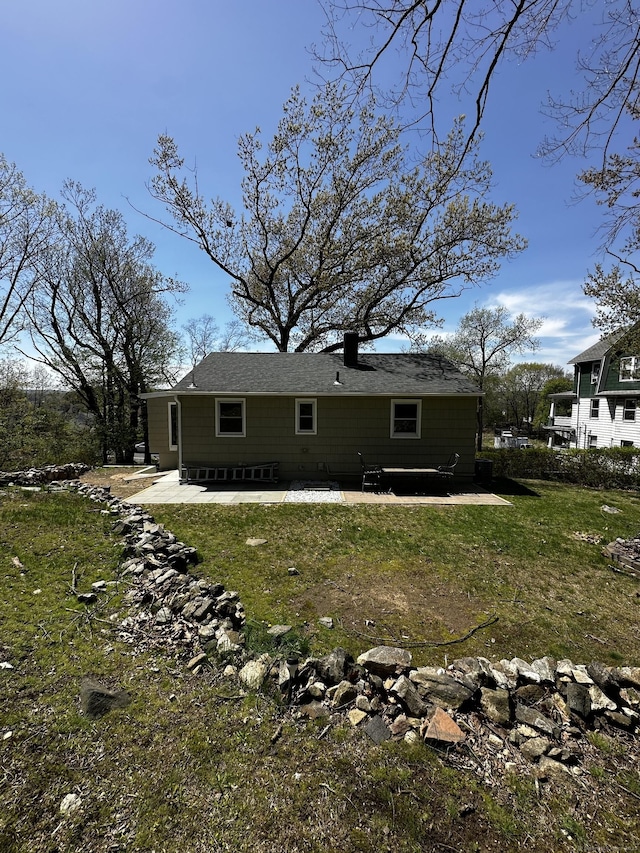 163 Sylvan Ave, Waterbury, CT 06706 - rear view of house with a patio area, a chimney, and a yard