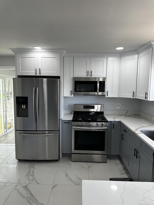163 Sylvan Ave, Waterbury, CT 06706 - kitchen with appliances with stainless steel finishes, gray cabinetry, light marble finish flooring, light stone countertops, and recessed lighting