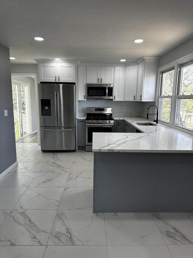 163 Sylvan Ave, Waterbury, CT 06706 - kitchen with appliances with stainless steel finishes, light stone counters, recessed lighting, light marble finish flooring, and plenty of natural light