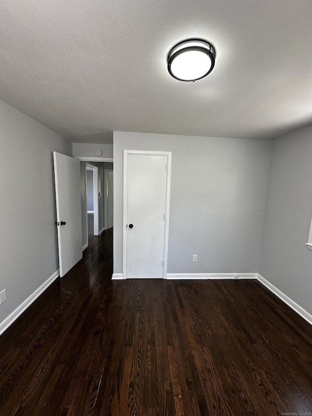 163 Sylvan Ave, Waterbury, CT 06706 - empty room with baseboards and dark wood-style floors