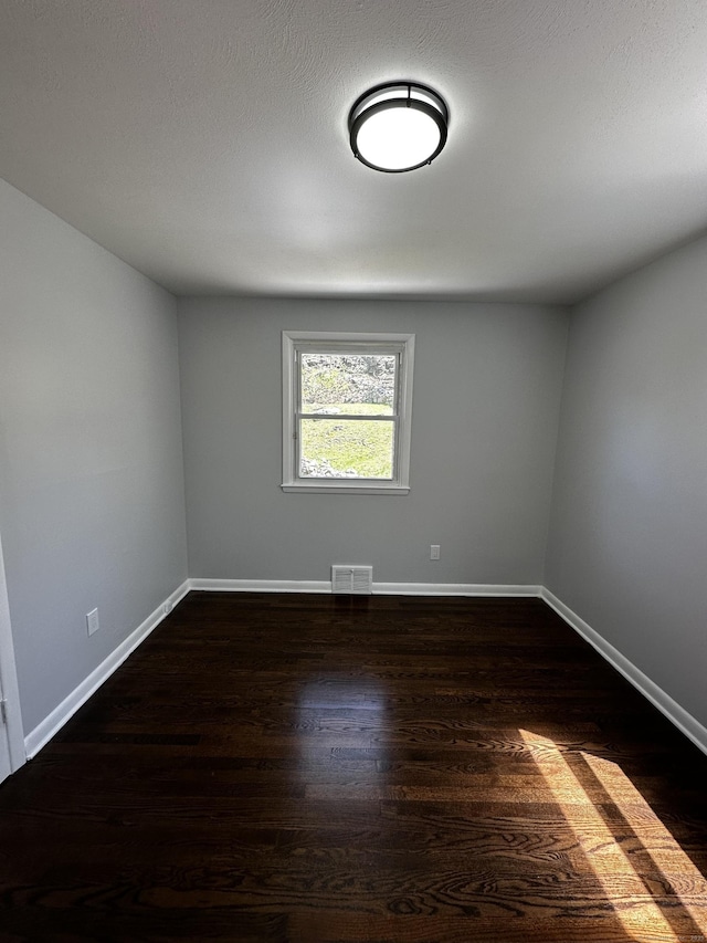 163 Sylvan Ave, Waterbury, CT 06706 - spare room featuring dark wood-type flooring and baseboards