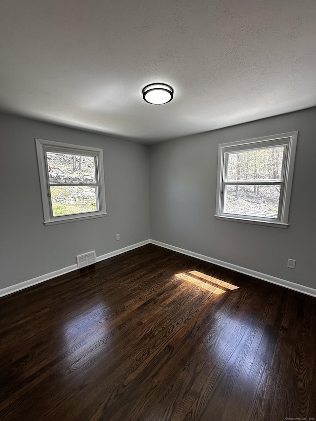 163 Sylvan Ave, Waterbury, CT 06706 - empty room with plenty of natural light and dark wood-style flooring