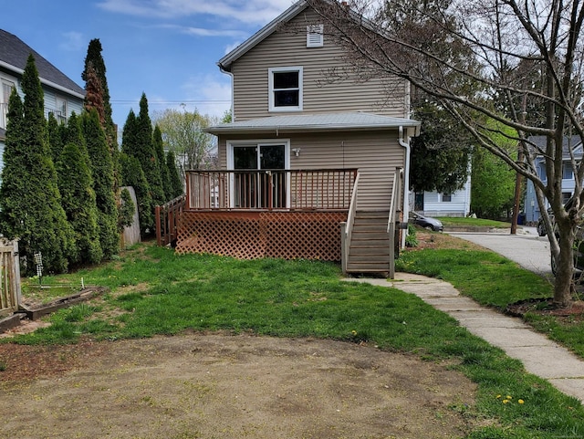 back of house featuring stairs, a yard, and a deck