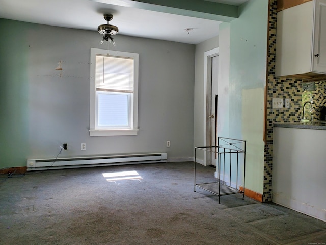 carpeted empty room featuring baseboards and baseboard heating