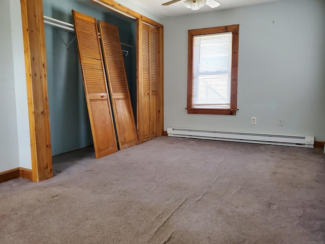 unfurnished bedroom featuring ceiling fan, baseboard heating, baseboards, a closet, and carpet flooring