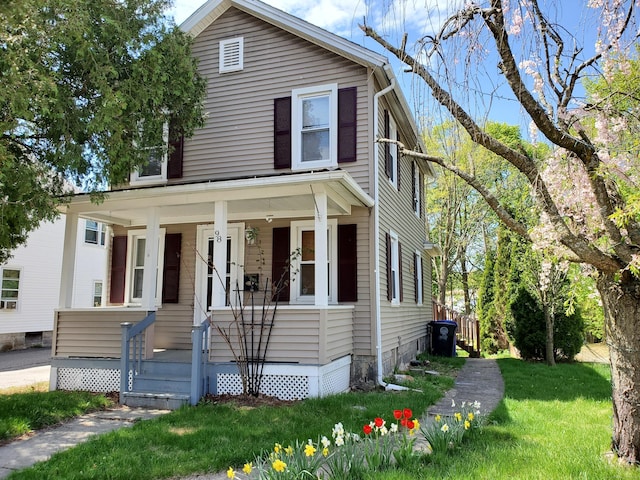 view of front facade with covered porch and a front yard