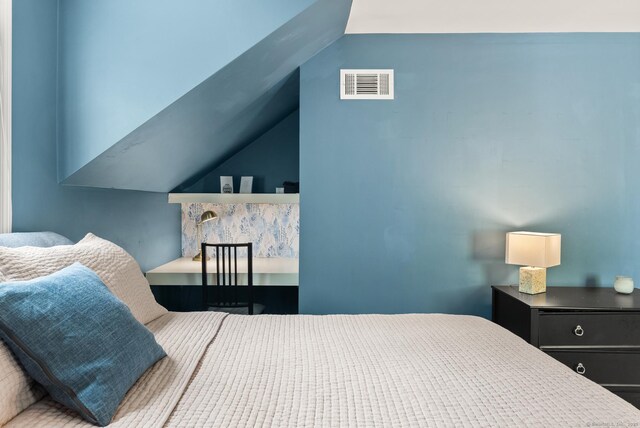 bedroom featuring visible vents and lofted ceiling