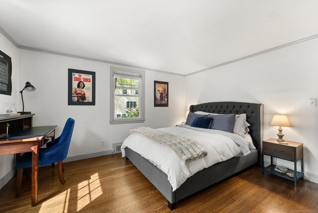 bedroom with wood finished floors, baseboards, and a desk