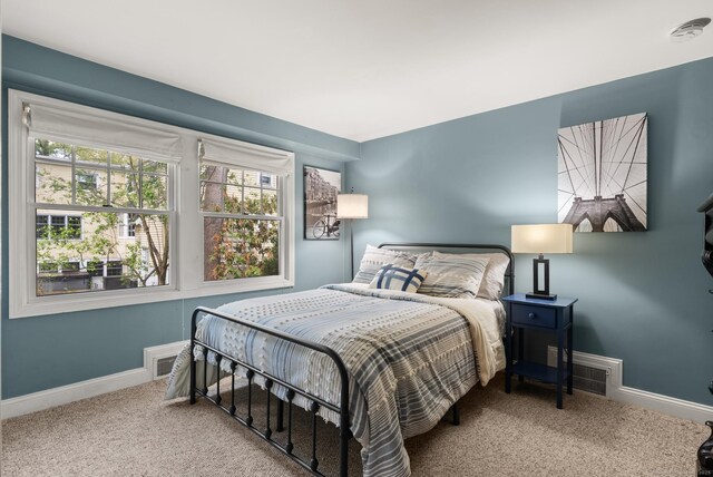 bedroom featuring carpet, visible vents, and baseboards