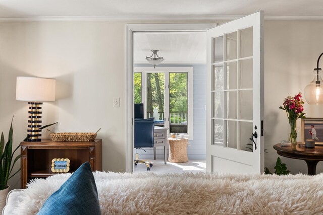 doorway to outside with crown molding and carpet