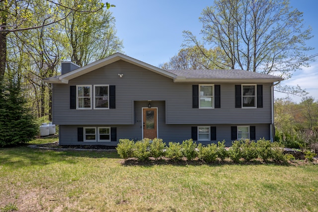 split foyer home with a front yard and a chimney