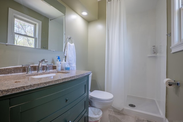 full bath with toilet, vanity, a shower stall, and tile patterned floors