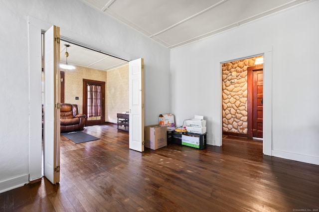 unfurnished room featuring baseboards and wood-type flooring