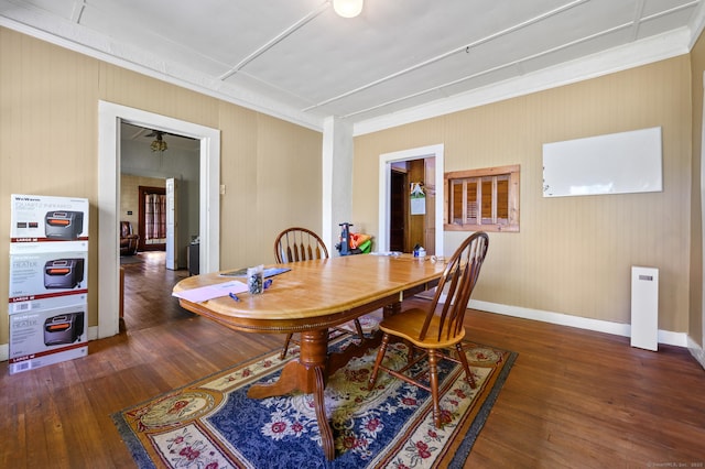 dining space with baseboards, ornamental molding, and hardwood / wood-style flooring