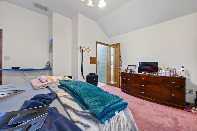 bedroom with an inviting chandelier, carpet, lofted ceiling, and visible vents