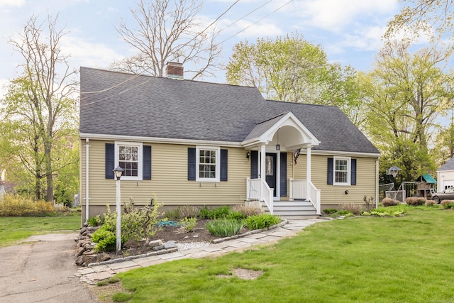 123 Hilltop Dr, Trumbull, CT 06611 - new england style home with a shingled roof, a front lawn, and a chimney