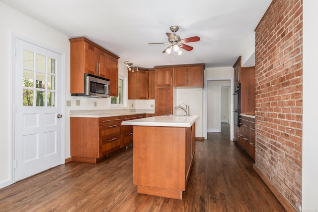 123 Hilltop Dr, Trumbull, CT 06611 - kitchen featuring a healthy amount of sunlight, brown cabinets, stainless steel microwave, and dark wood finished floors