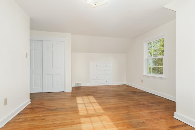 123 Hilltop Dr, Trumbull, CT 06611 - additional living space with visible vents, light wood-style floors, baseboards, and vaulted ceiling