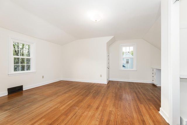 123 Hilltop Dr, Trumbull, CT 06611 - additional living space with baseboards, visible vents, vaulted ceiling, and light wood-type flooring