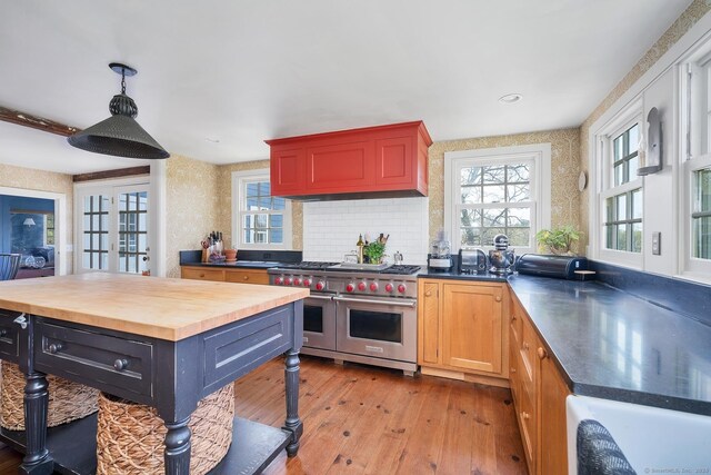 149 Limekiln Rd, Redding, CT 06896 - kitchen featuring double oven range, light wood-style floors, butcher block counters, custom exhaust hood, and tasteful backsplash