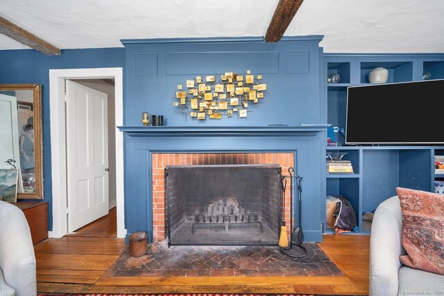 149 Limekiln Rd, Redding, CT 06896 - detailed view of a brick fireplace, beamed ceiling, and wood finished floors