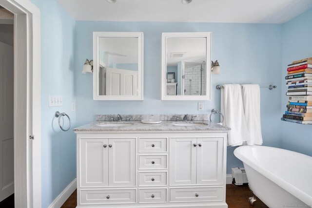 149 Limekiln Rd, Redding, CT 06896 - full bathroom with double vanity, a freestanding tub, a baseboard radiator, and a shower