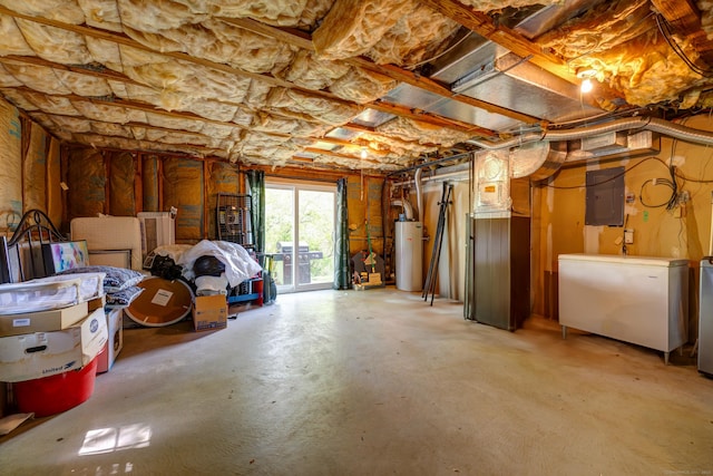 basement with gas water heater, electric panel, and fridge