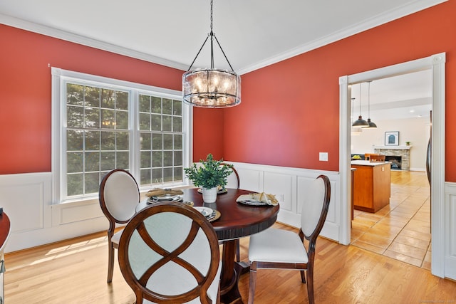 41 Madison Way S, Windsor, CT 06074 - dining area featuring a chandelier, wainscoting, ornamental molding, a fireplace, and light wood finished floors