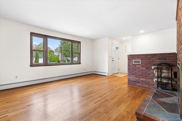 unfurnished living room with recessed lighting, visible vents, wood finished floors, and a baseboard radiator